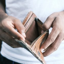 person holding brown leather bifold wallet